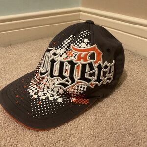 Stylish black cap with bold orange and white graphics. Perfect for casual wear.
